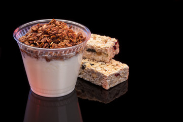 Yogurt with chocolade granola and granola bar with fruits and nuts