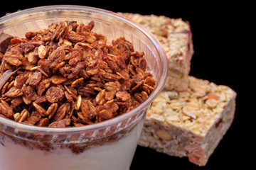 Yogurt with chocolade granola and granola bar with fruits and nuts