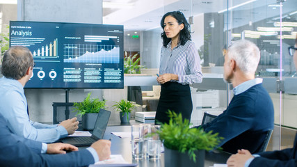 Beautiful Businesswoman Gives Report/ Presentation to Her Business Colleagues in the Conference...