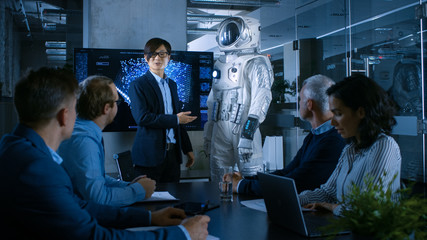 In the Conference Room Chief Engineer Presents Next Generation Space Suit to a Board of Directors. Completely Original Design with Integrated AI and Neural Network Systems. New Level of Space Travel.