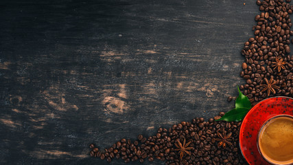 Hot coffee American in a cup. Cinnamon. On a black wooden background. Top view. Copy space. - obrazy, fototapety, plakaty