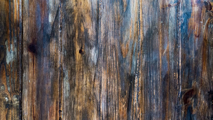 Old wooden planks with degraded blue paint over it.