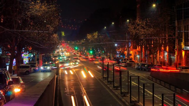 Time lapse video of cars with a long exposure at night in Yerevan on street Mashtots. The camera moves away