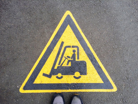 Forklift Truck Sign On The Black Asphalt