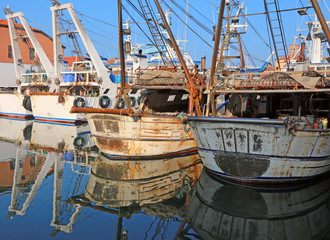 fishing boats moored in the water canal by the sea