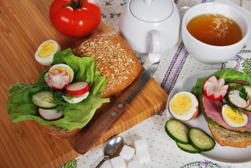 sandwich with lettuce ham with egg and radish with hot tea for a healthy breakfast