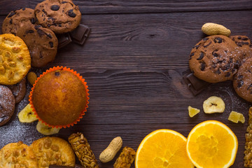 homemade cookies with chocolate lies on a dark background of wood