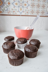 Tasty cupcakes on background table. Homemade chocolate muffin cupcake with cream buttercream icing. Birthday cupcake. Valentine cupcake sweets. Close up view delicious sweet dessert