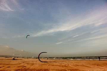 Wakeboarders arrange the sails on the beach after the competition.After the race the participants...