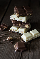 Chocolate bar of white and dark chocolate on wooden background