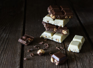 Chocolate bar of white and dark chocolate on wooden background