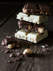 Chocolate bar of white and dark chocolate on wooden background