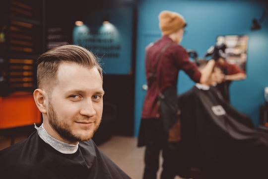 Barbershop. Man with beard in barber shop. Modern hair salon