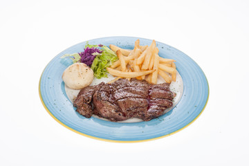 Roasted veal fillet with French fries and salad