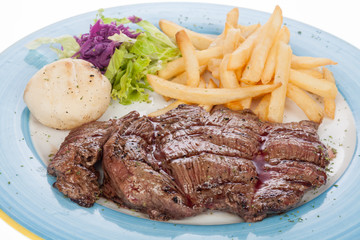 Roasted veal fillet with French fries and salad