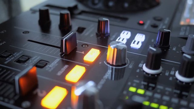 Close up of Hand Increasing Sound of DJ Instrument, Moving Fader