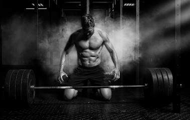 Muscular man workout with barbell