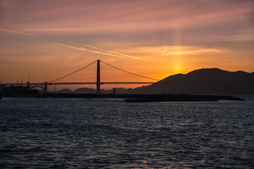 Naklejka na ściany i meble Sunset over bridge in San Francisco