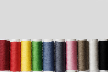 Set of colorful sewing threads on white background