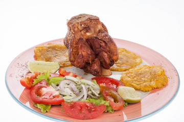 fried pork knuckle with salad and patacones