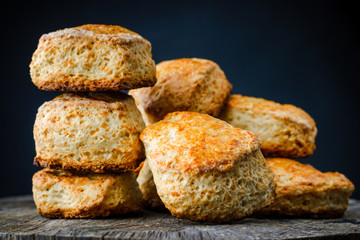 traditional English cheese buns scones on wooden table on dark background