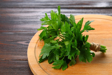 Fresh green parsley on the wooden table, selective focus.