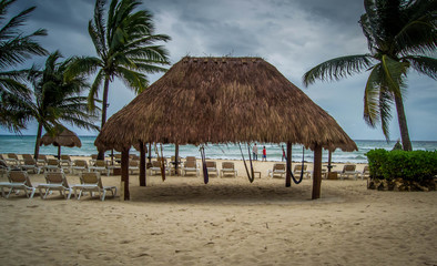 Fototapeta na wymiar Four hanging hammocks at the beach