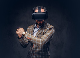 Studio portrait of a man wearing virtual reality glasses on a da