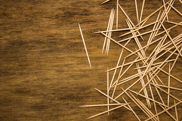 many toothpicks on the brown table background