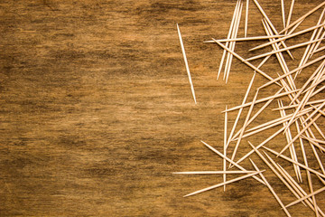 many toothpicks on the brown table background