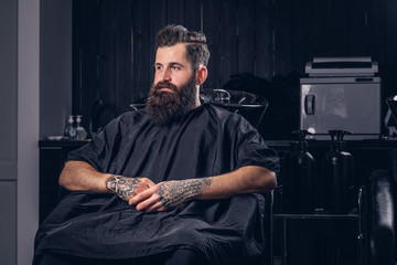 Handsome bearded man in the barbershop.