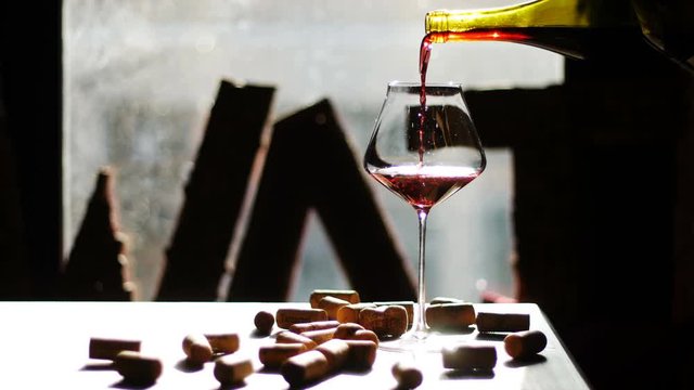 Pouring red wine into glass. Seamless cinemagraph video