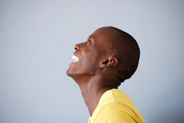 Profile portrait of happy man laughing and looking up