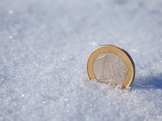 Coin 1 Euro in the snow.
