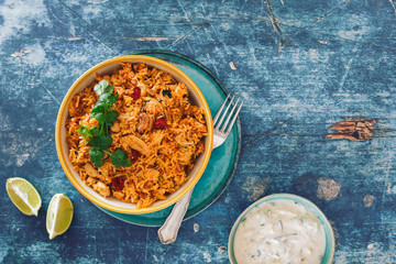 Hyderabadi chicken biryani on rustic table. Top view, blank space
