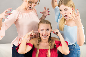 Woman being bullied by two females