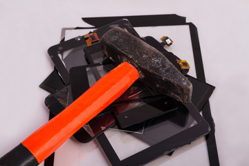 broken touchscreens lie a bunch of them on a hammer. service for gadget repair. concept