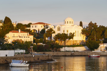 Houses and a church in the harbor of Spetses village, Greece. 
