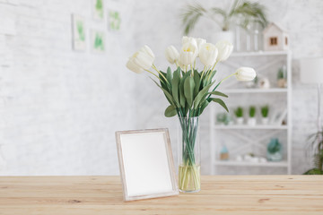 Tulips in a vase on a wooden table. Scandinavian interior. Mockup.