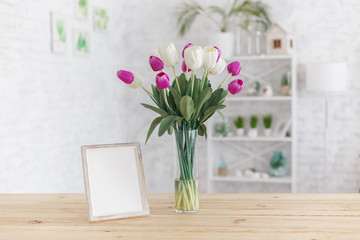 Tulips in a vase on a wooden table. Scandinavian interior. Mockup.