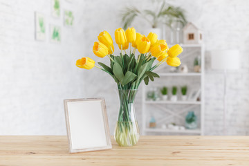 Tulips in a vase on a wooden table. Scandinavian interior. Mockup.