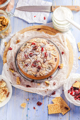 Banana cake with nuts, sesame and cranberry on a wooden table