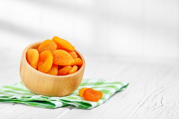 Delicious dried apricots and raisins in the bowl. Square. The concept is healthy food, vegetarianism, diet, vitamins.