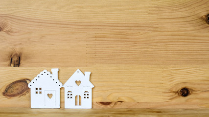 Obraz na płótnie Canvas White Small Houses on a Wooden Background