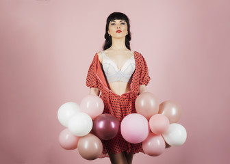 Brunette with serious face, bright lips and beautiful breasts.