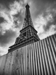 A glimpse of the Eiffel Tower and iron barriers to counteract any terrorist attacks.