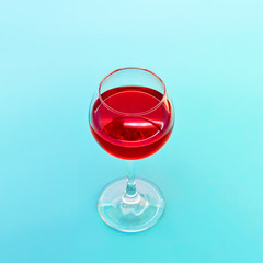 A Glass Of Red Wine On Blue Background