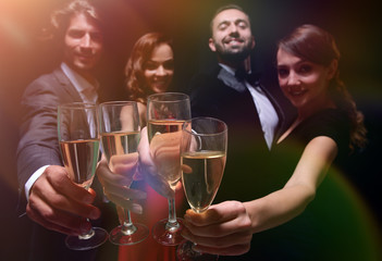 Cheerful people celebrating a sucess with Champagne
