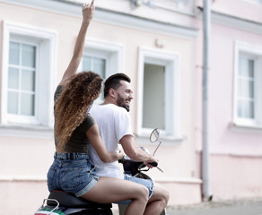 Cool man and beautiful girl riding on  scooter with  expression