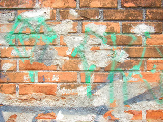Brick wall with graffiti.